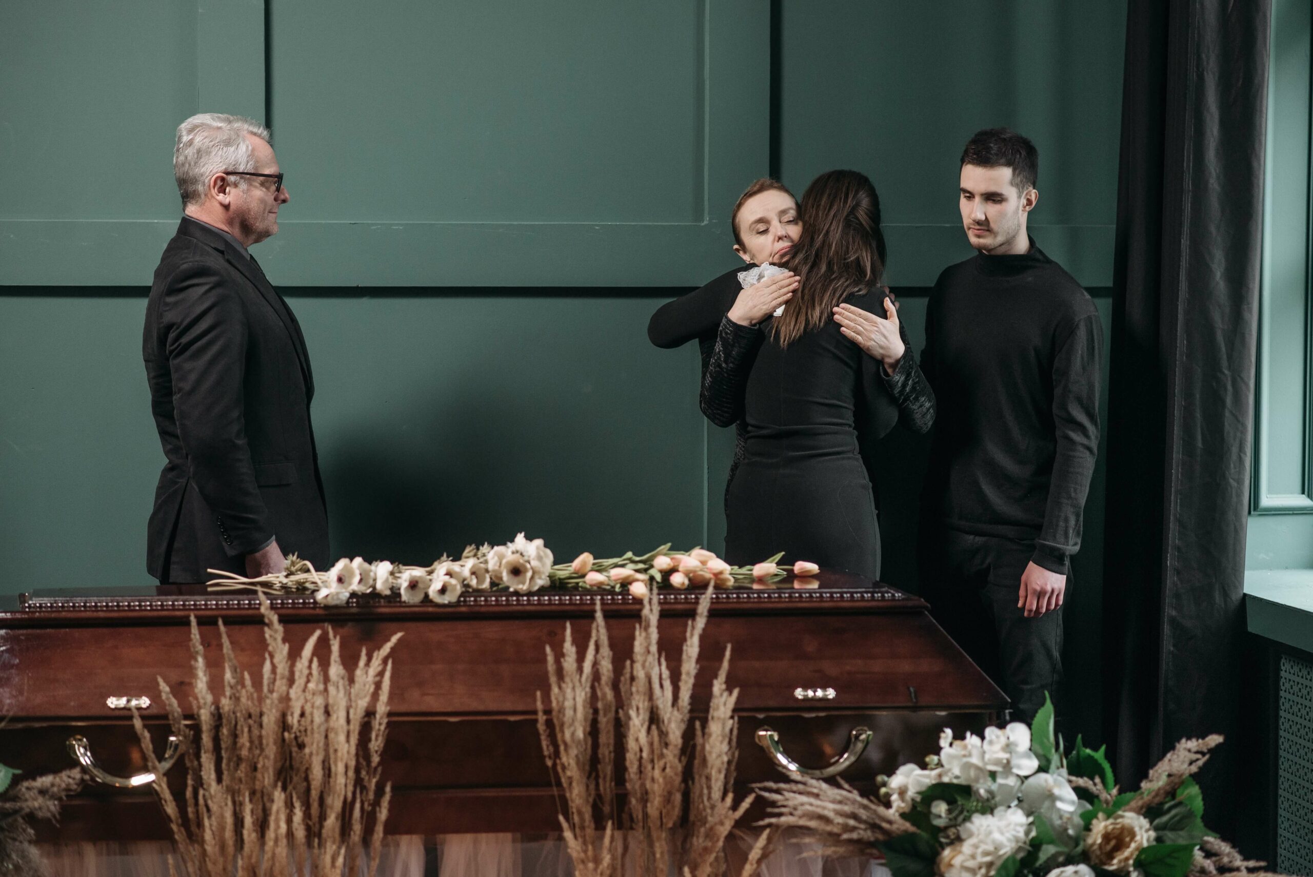 people at a funeral hugging